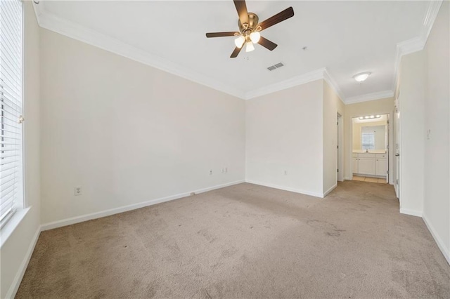 carpeted empty room with crown molding and ceiling fan