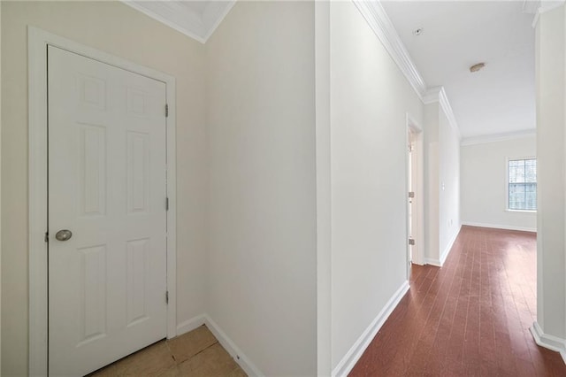 hallway featuring ornamental molding and dark hardwood / wood-style floors