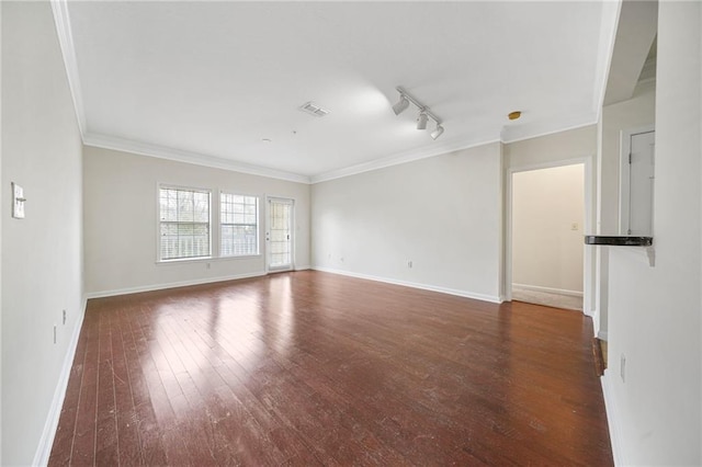 empty room featuring ornamental molding, dark hardwood / wood-style flooring, and rail lighting