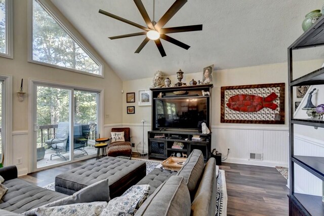 living room with high vaulted ceiling, ceiling fan, and dark wood-type flooring