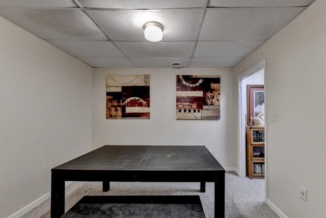 recreation room featuring carpet flooring and a paneled ceiling