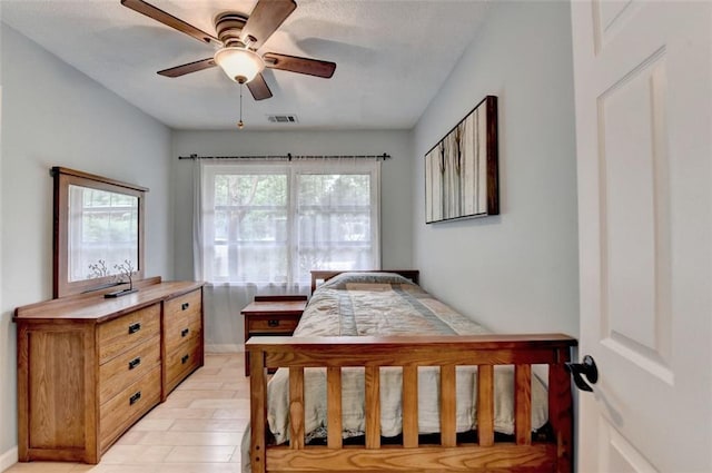 bedroom featuring a ceiling fan, baseboards, and visible vents