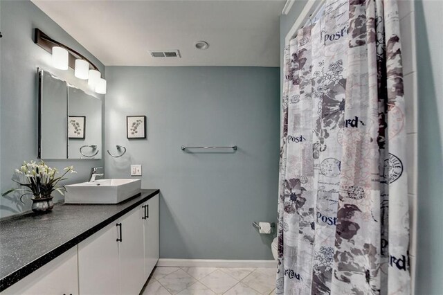 full bath featuring visible vents, baseboards, vanity, marble finish floor, and a shower with shower curtain