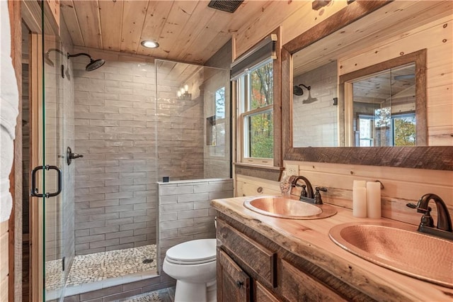 full bathroom with a stall shower, wood ceiling, a sink, and toilet