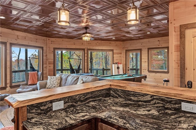 rec room with an ornate ceiling, a ceiling fan, wood walls, and billiards