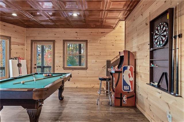 recreation room featuring an ornate ceiling, wooden walls, and wood finished floors