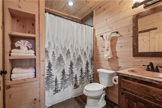 full bath featuring toilet, wood ceiling, wooden walls, and vanity