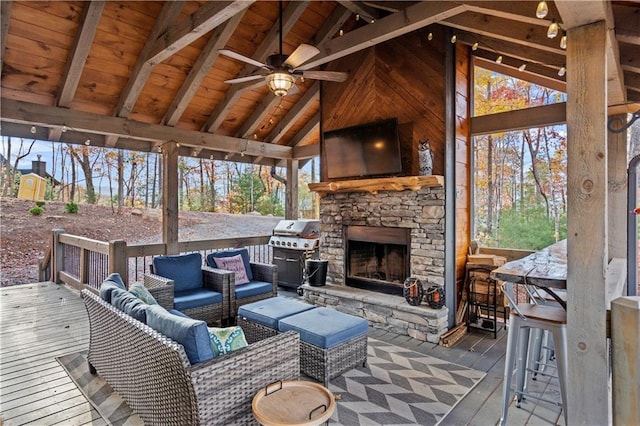 wooden terrace featuring grilling area and an outdoor living space with a fireplace