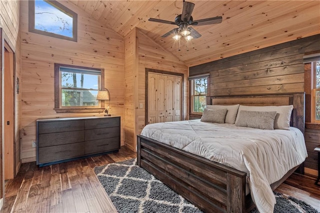 bedroom featuring a ceiling fan, hardwood / wood-style flooring, wood ceiling, wood walls, and high vaulted ceiling