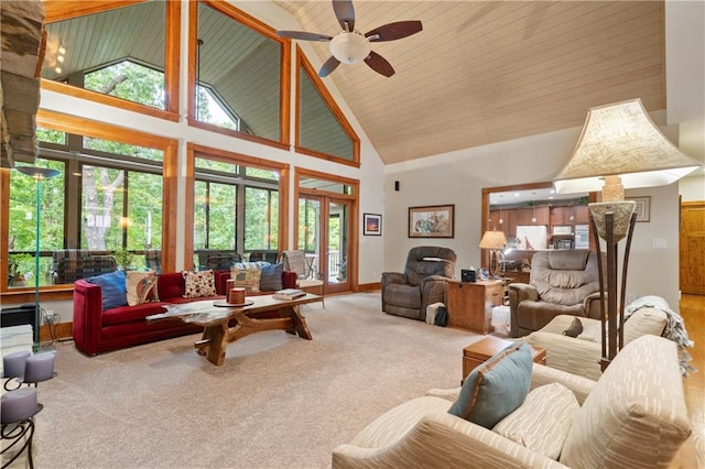 living room with high vaulted ceiling, ceiling fan, and carpet