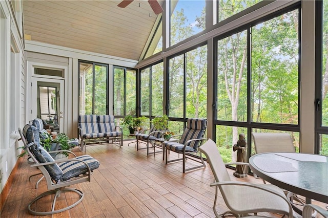 sunroom / solarium with lofted ceiling, a wealth of natural light, and ceiling fan