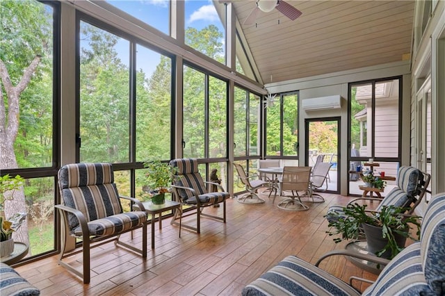 sunroom / solarium with a wall mounted air conditioner, vaulted ceiling, and ceiling fan