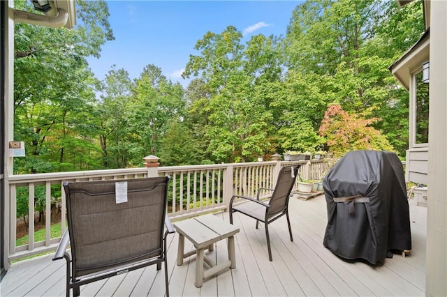 wooden terrace featuring a grill