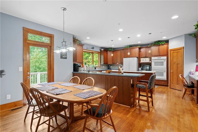 dining space with light hardwood / wood-style floors