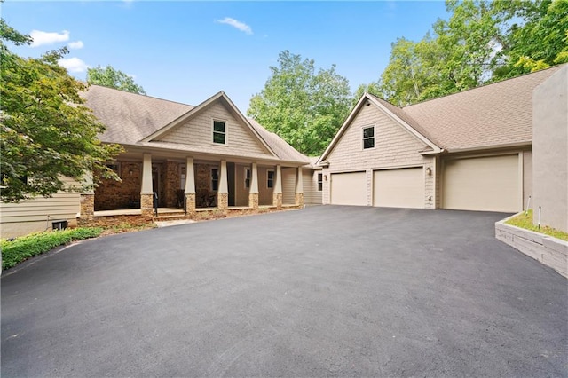 view of front of property featuring a porch and a garage