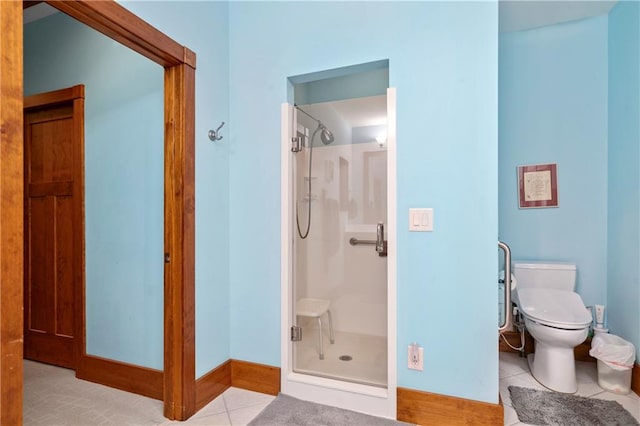 bathroom with tile patterned floors, toilet, and an enclosed shower