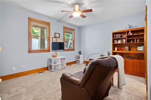 sitting room featuring ceiling fan and light carpet