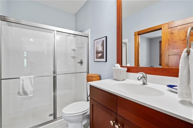 bathroom with vanity, toilet, and an enclosed shower