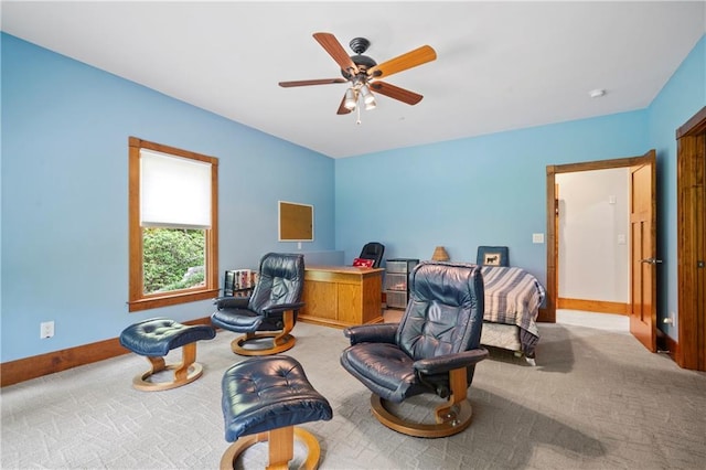 living area with ceiling fan and light colored carpet