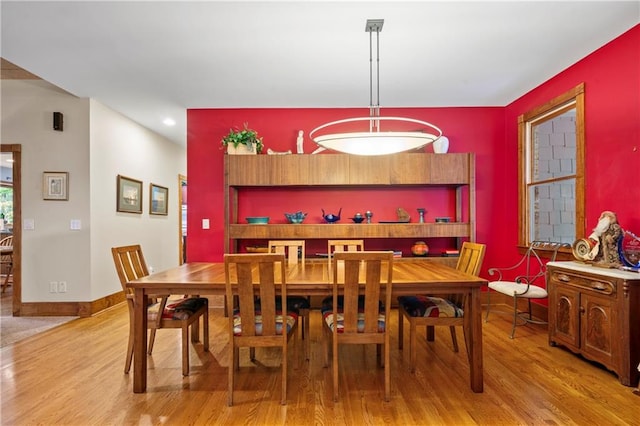 dining space with light hardwood / wood-style flooring