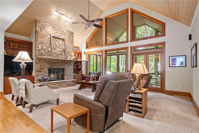 carpeted living room with built in features, high vaulted ceiling, a fireplace, wood ceiling, and track lighting