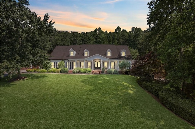 new england style home featuring a lawn