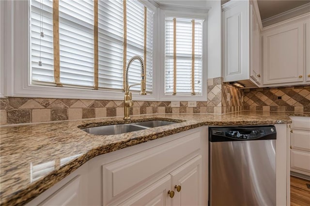 kitchen featuring white cabinetry, dishwasher, sink, backsplash, and light stone counters