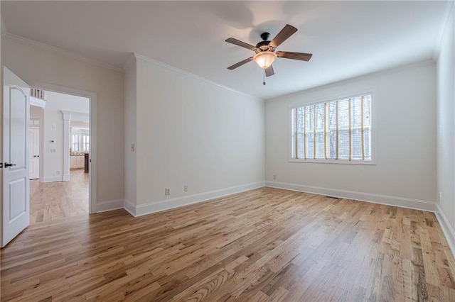 empty room with ornamental molding, light hardwood / wood-style floors, and ceiling fan