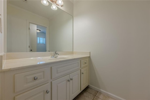 bathroom featuring crown molding, vanity, and tile patterned flooring