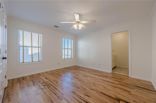 spare room featuring crown molding, ceiling fan, and light hardwood / wood-style floors