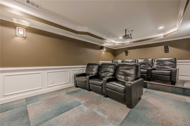 home theater with crown molding and a raised ceiling