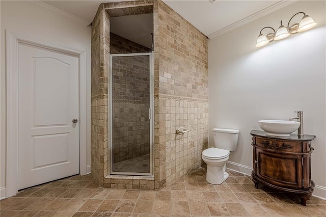 bathroom featuring an enclosed shower, vanity, ornamental molding, and toilet