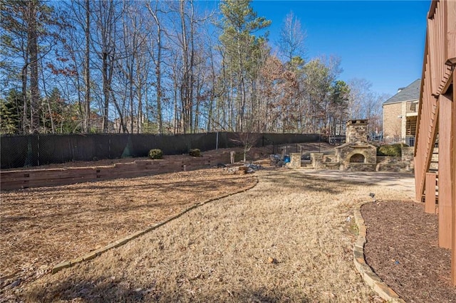 view of yard featuring a fireplace