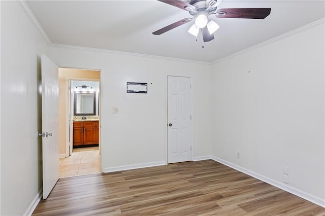 602 Country Park Dr SE, Smyrna, GA 30080 - spare room with light wood finished floors, a ceiling fan, crown molding, and baseboards