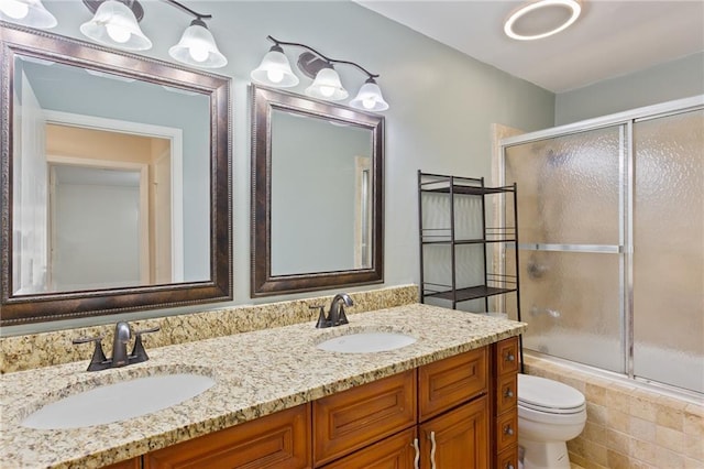 602 Country Park Dr SE, Smyrna, GA 30080 - bathroom with toilet, shower / bath combination with glass door, and double vanity