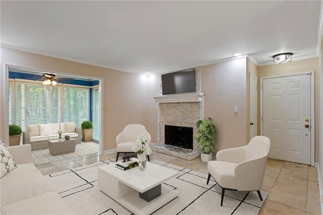 602 Country Park Dr SE, Smyrna, GA 30080 - living room with crown molding, a fireplace with raised hearth, light tile patterned floors, ceiling fan, and baseboards