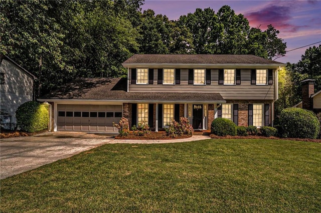 1703 W Nancy Creek Dr NE, Brookhaven, GA 30319 - view of front of house featuring a garage, driveway, a lawn, and brick siding
