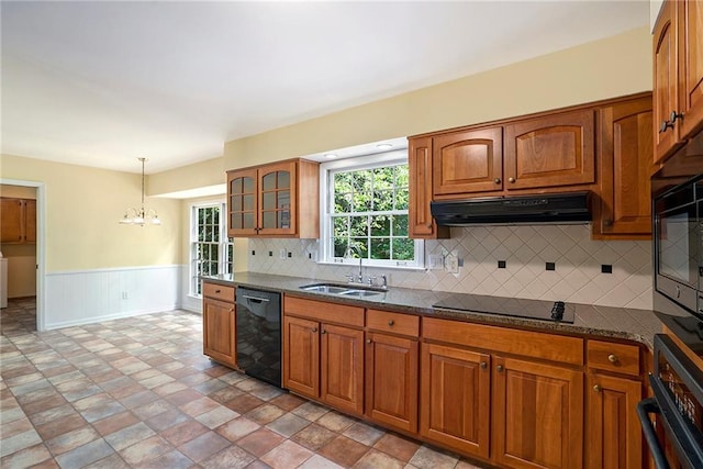 1703 W Nancy Creek Dr NE, Brookhaven, GA 30319 - kitchen featuring black appliances, under cabinet range hood, a sink, a chandelier, and brown cabinets