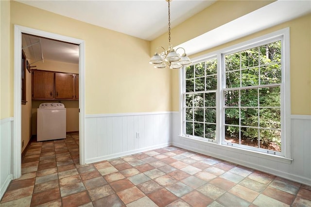 1703 W Nancy Creek Dr NE, Brookhaven, GA 30319 - unfurnished dining area featuring washer / clothes dryer, stone finish floors, wainscoting, and a chandelier