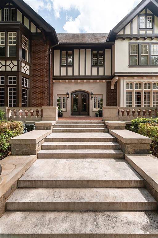 entrance to property with french doors and stucco siding