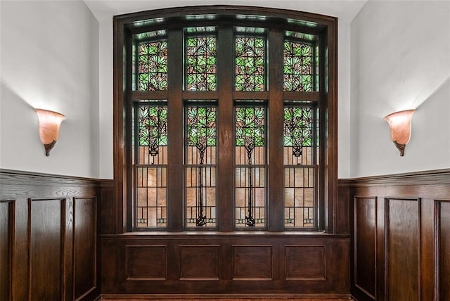 entryway featuring plenty of natural light and wainscoting