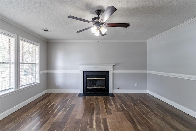 7384 Birch Hollow Pl, Douglasville, GA 30134 - unfurnished living room featuring dark wood-type flooring, a ceiling fan, a textured ceiling, a fireplace with flush hearth, and crown molding
