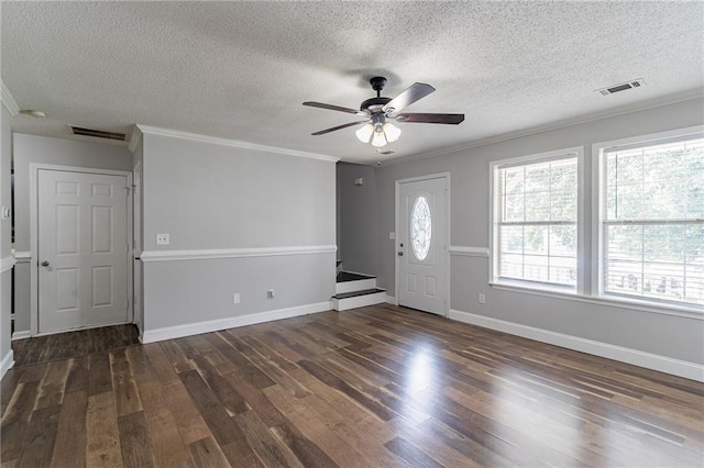 7384 Birch Hollow Pl, Douglasville, GA 30134 - foyer entrance with dark wood finished floors, ornamental molding, a ceiling fan, a textured ceiling, and baseboards