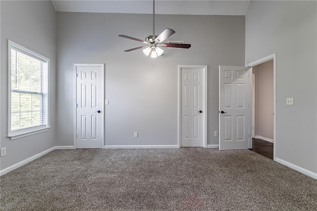 7384 Birch Hollow Pl, Douglasville, GA 30134 - unfurnished bedroom with high vaulted ceiling, carpet, baseboards, and two closets