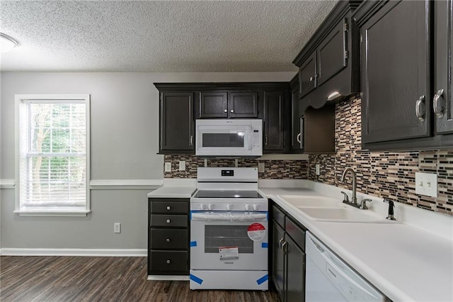 7384 Birch Hollow Pl, Douglasville, GA 30134 - kitchen with white appliances, a sink, a textured ceiling, dark wood-style floors, and tasteful backsplash