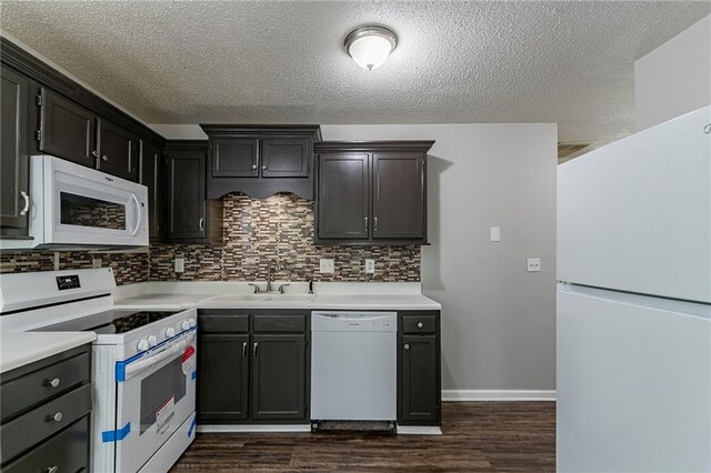 7384 Birch Hollow Pl, Douglasville, GA 30134 - kitchen featuring white appliances, a sink, dark wood-type flooring, tasteful backsplash, and a textured ceiling