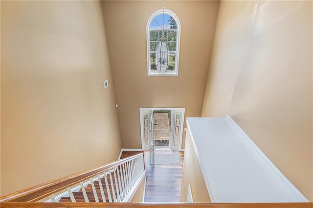 48 Savanna Ct, Powder Springs, GA 30127 - stairs featuring a towering ceiling and wood finished floors