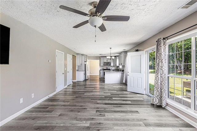 48 Savanna Ct, Powder Springs, GA 30127 - unfurnished living room featuring a textured ceiling, dark wood-style floors, a ceiling fan, and baseboards