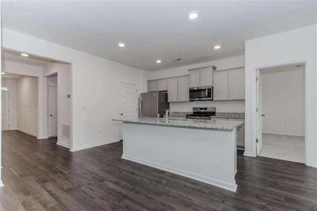 977 Daurian Dr, Statham, GA 30666 - kitchen with appliances with stainless steel finishes, gray cabinetry, a center island with sink, dark wood-style floors, and recessed lighting
