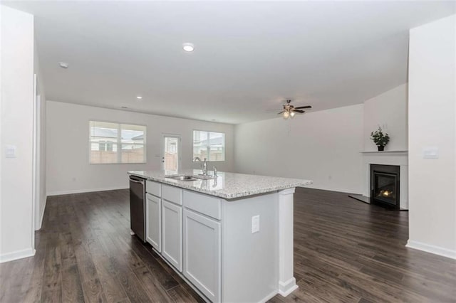 977 Daurian Dr, Statham, GA 30666 - kitchen with open floor plan, a center island with sink, dark wood-style floors, stainless steel dishwasher, and recessed lighting
